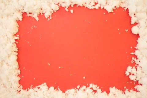 Top view of snow frame on red background with copy space Stock Photos