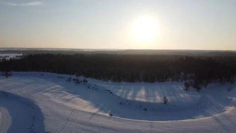 Top view of the snowy fields and forest. Quadrocopter shooting at sunset Stock-Footage 125316849