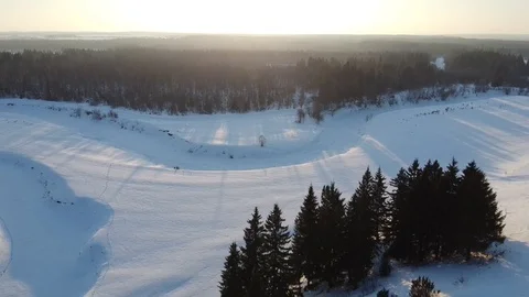 Top view of the snowy fields and forest. Quadrocopter shooting at sunset Stock-Footage 125317007