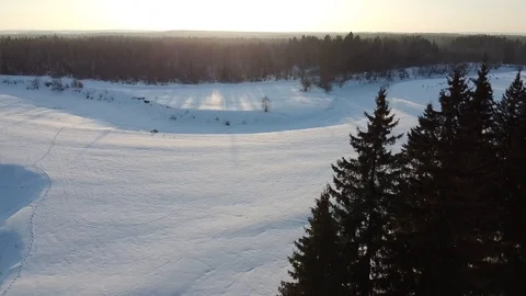 Top view of the snowy fields and forest. Quadrocopter shooting at sunset Stock-Footage 125317119