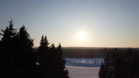 Top view of the snowy fields and forest. Quadrocopter shooting at sunset Stock-Footage 125317153