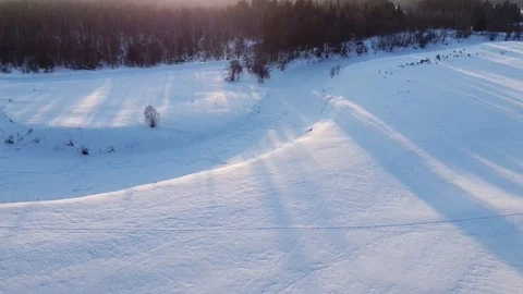 Top view of the snowy fields and forest. Quadrocopter shooting at sunset Stock-Footage 125317214