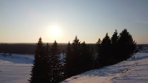 Top view of the snowy fields and forest. Quadrocopter shooting at sunset Stock-Footage 125317347