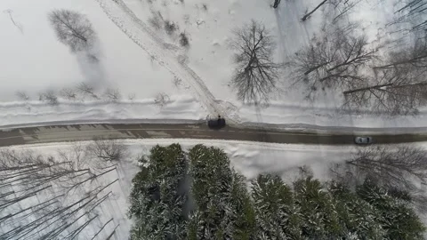 Top view of snowy mountain landscape with road and driving cars Stock Footage 300986266