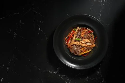 Top view, Soba beef and vegetables, Buckwheat noodles on a dark stone backgro Stock Photos