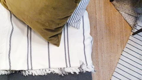 Top view of sofa, pillows, blanket and carpet. Abstract textured background Stock Photos