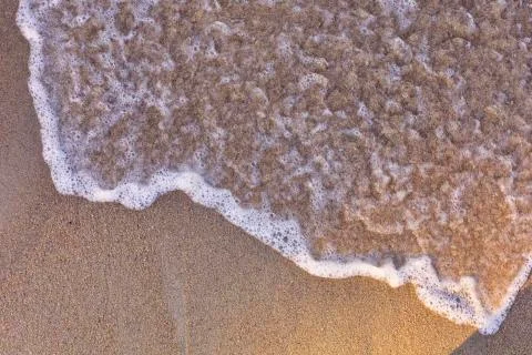 Top view Soft wave from sea come to wet sand beach background. With copy spac Stock Photos