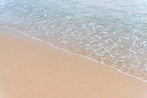 Top view Soft wave from sea come to wet sand beach background. With copy spac Stock Photos