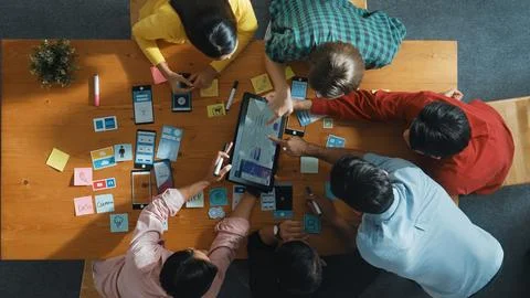Top view of software developer team looking Ux design from tablet. Convocation. Stock Photos