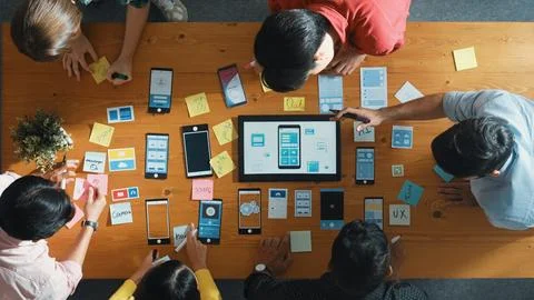 Top view of software developer team looking Ux design from tablet. Convocation. Stock Photos