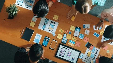 Top view of software developer team looking Ux design from tablet. Convocation. Stock Photos