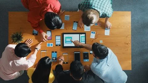 Top view of software developer team looking Ux design from tablet. Convocation. Stock Photos