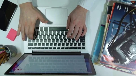 Top view software engineer drinking coffee using laptop computer at desk from Stock Footage 72954234