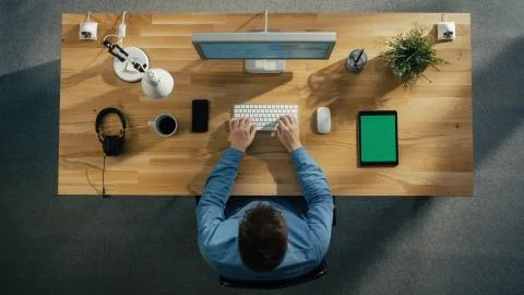 Top View of a Software Engineer Typing on His Desktop Computer. Tablet Computer Stock Photos