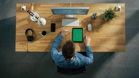 Top View of a Software Engineer Typing on His Desktop Computer. Tablet Computer Stock Photos