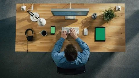 Top View of a Software Engineer Working at His Desktop Computer Stock Photos