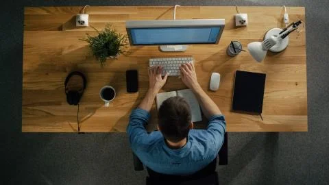 Top View of a Software Engineer Working on a Desktop Computer Stock Photos