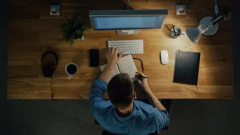 Top View of a Software Engineer Working on a Desktop Computer Stock Photos