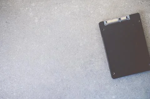 Top view of solid-state drive on a rough textured background with copy space Stock Photos