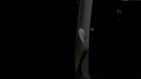 Top view of soluble pill / tablet falling / dropping in a glass with water Stock Footage 153514015