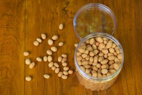 Top view of some dried atomic Nuts and food storage or jars on wooden table Stock Photos