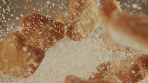 Top view of сookies are flying up with powdered sugar in slow motion Stock Footage 120080529