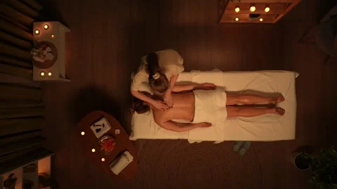 Top view of spa salon room, female laying on massage table, professional Stock Footage 252394539