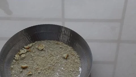 Top view of a sparrow picking grains from the steel bowl Stock Footage 135411114