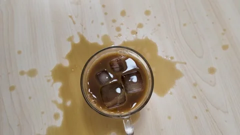 Top View of Spilled Iced Coffee in Glass Mug on Table Stock Footage 341932814