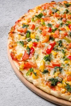 Top view of spinach vegetable pizza with colorful fresh ingredients Stock Photos