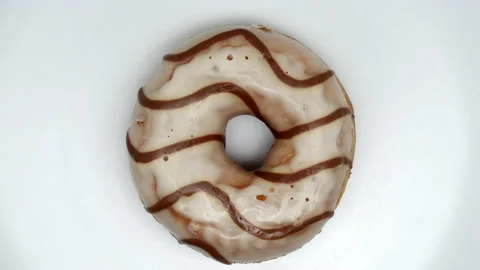 Top View Spinning Donut Glazed With White Icing With Brown Curls On A White Back Vídeo Stock 150090711