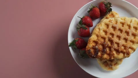 Top view of spinning half white plate filled croffle and strawberries Stock Footage 280153694
