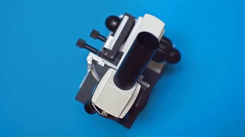Top view of spinning microscope on blue ... | Stock Video | Pond5