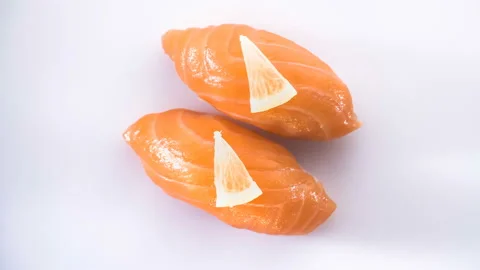 Top view of spinning two salmon sushi with lemon slices. Stock-Footage 124742395