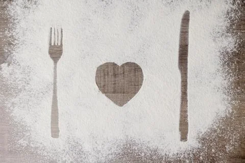 Top view of spoon and fork silhouette made with flour Stock Photos