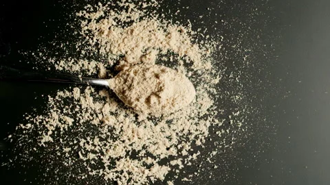 TOP VIEW: Spoon with ginger powder fall on a black table. Slow motion, Splash. Stock Footage 142914485