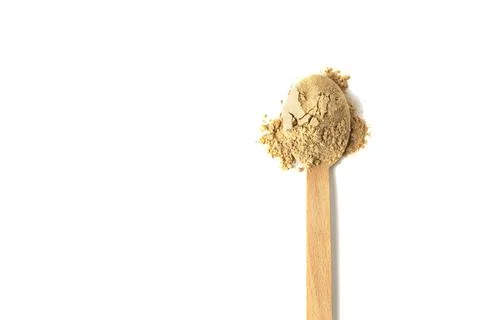 Top view of a spoon with maca root powder isolated on white Fotos de archivo