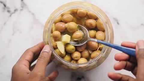 Top view of spoon pick olive from a jar Stock Footage 340123236
