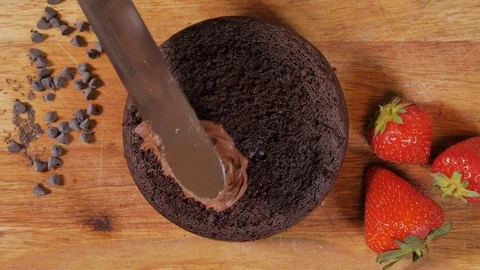 Top view : spread chocolate cream on the cake. garnish chocolate cake.  chocolat Stock Footage 111633011
