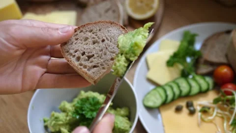 Top view of spreading mashed avocado on slice of wholegrain bread. Healthy 스톡 동영상 138443844