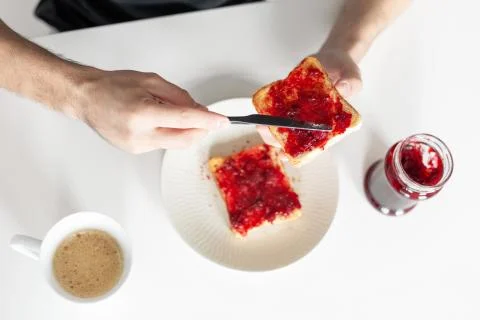 Top view spreads cherry jam on toast Stock Photos