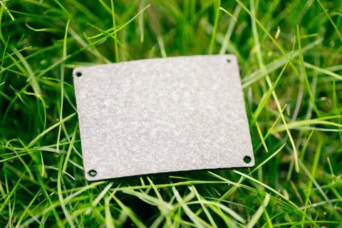 Top view of square gray leather patch for clothing creative layout of lawn green Stock Photos