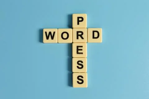 Top view of square letters with text WORDPRESS on blue background Stock Photos