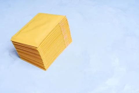 Top View of a Stack of Bubble Mailers on Grey Stock Photos