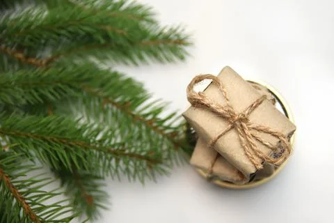 Top view stack of craft little gifts standing on round gold mirror on white b Stock-Fotos