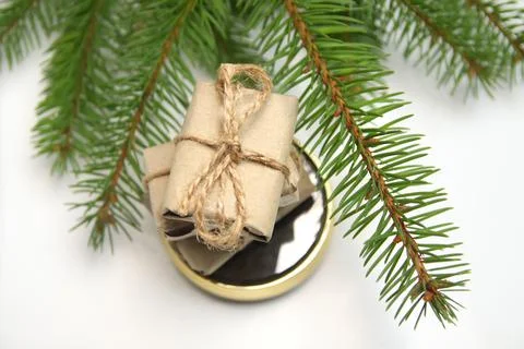 Top view stack of craft little gifts standing on round gold mirror on white b Stock Photos