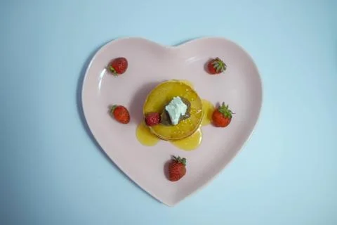 Top view of stack of delicious fluffy pancakes with fresh strawberries, honey Stock Photos