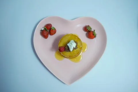 Top view of stack of delicious fluffy pancakes with fresh strawberries, honey Stock Photos