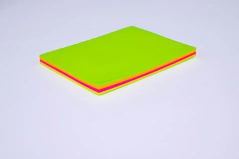 Top view of a stack of different colored paper sticky notes on top of a desk Stock Photos