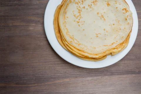 Top view of stack fried thin pancakes on wooden background Stock Photos